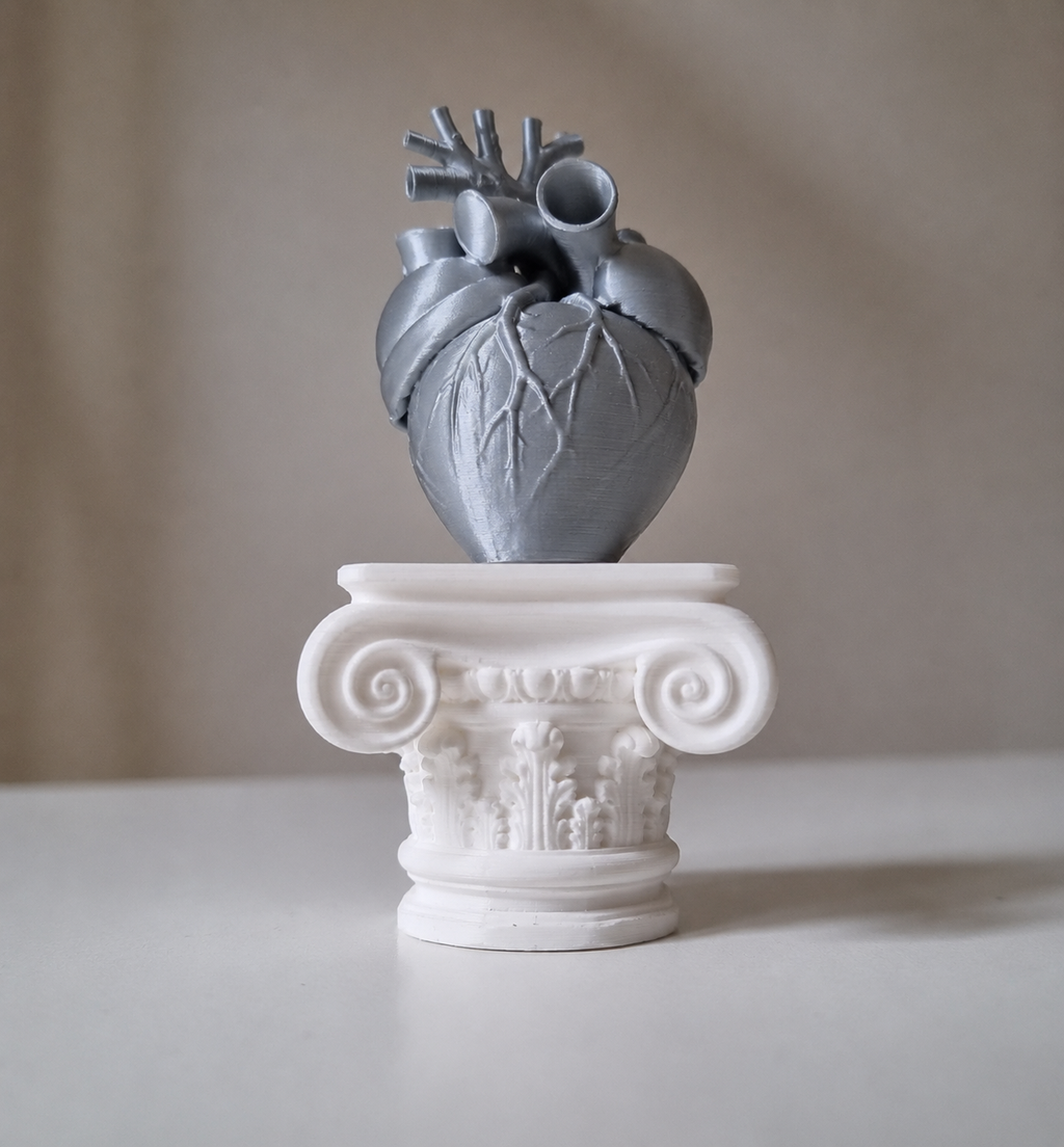 Cuore umano su capitello greco in stampa 3d grigio metal